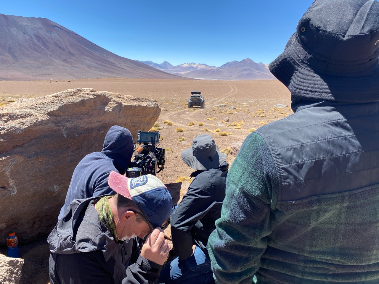 The Nissan Ariya electric vehicle navigating the rugged, high-altitude terrain of the Atacama Desert in Chile during the global Pole to Pole campaign, with local service production executed by ABSA Films.